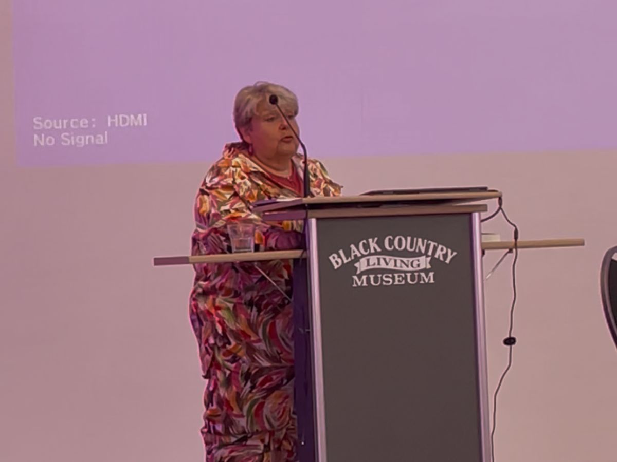 An image of Wendy Garcarz, at the Black Country Living Museum's stage, standing behind a podium.
